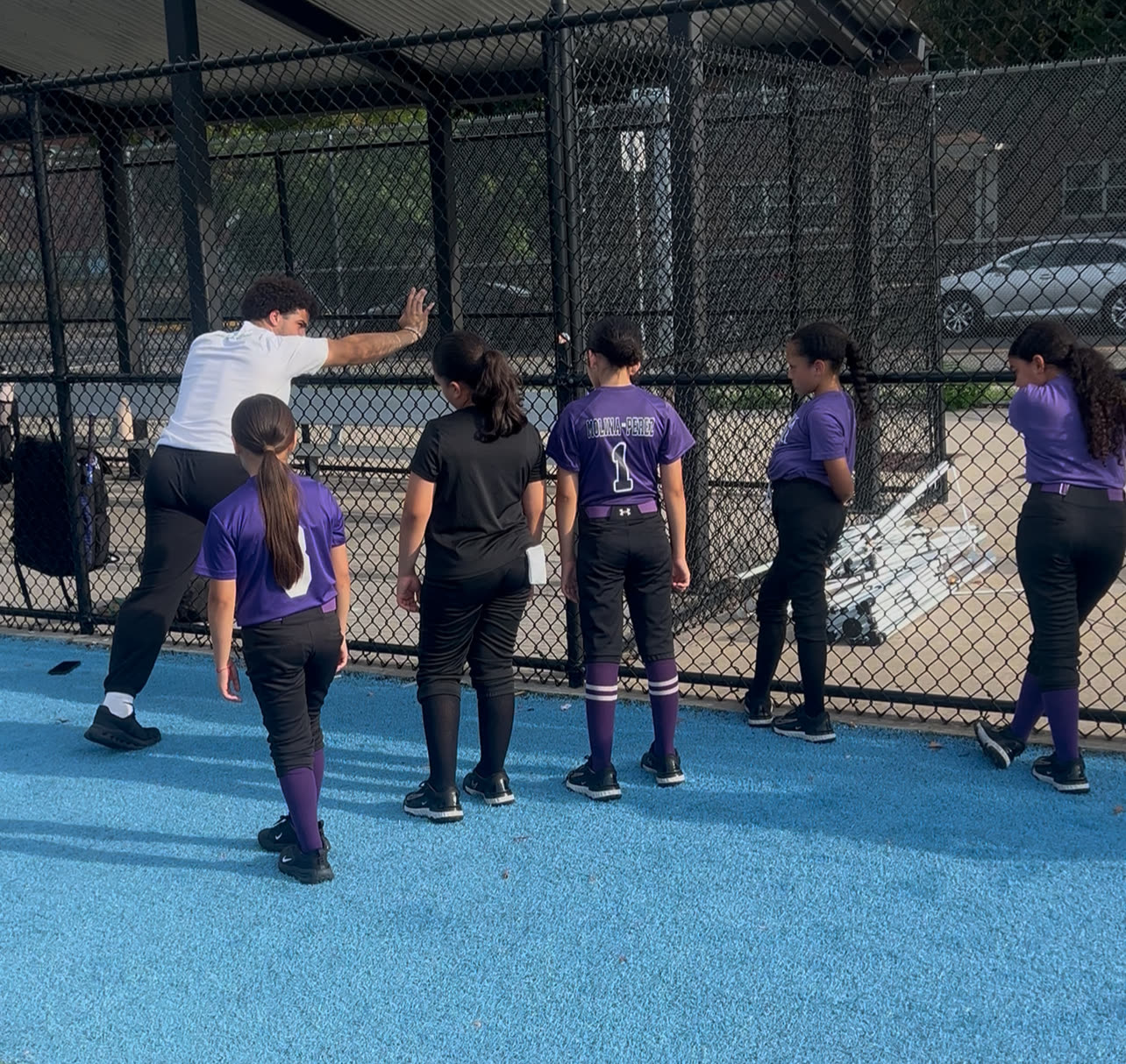 A Plus2 coach demonstrates a movement drill for young athletes