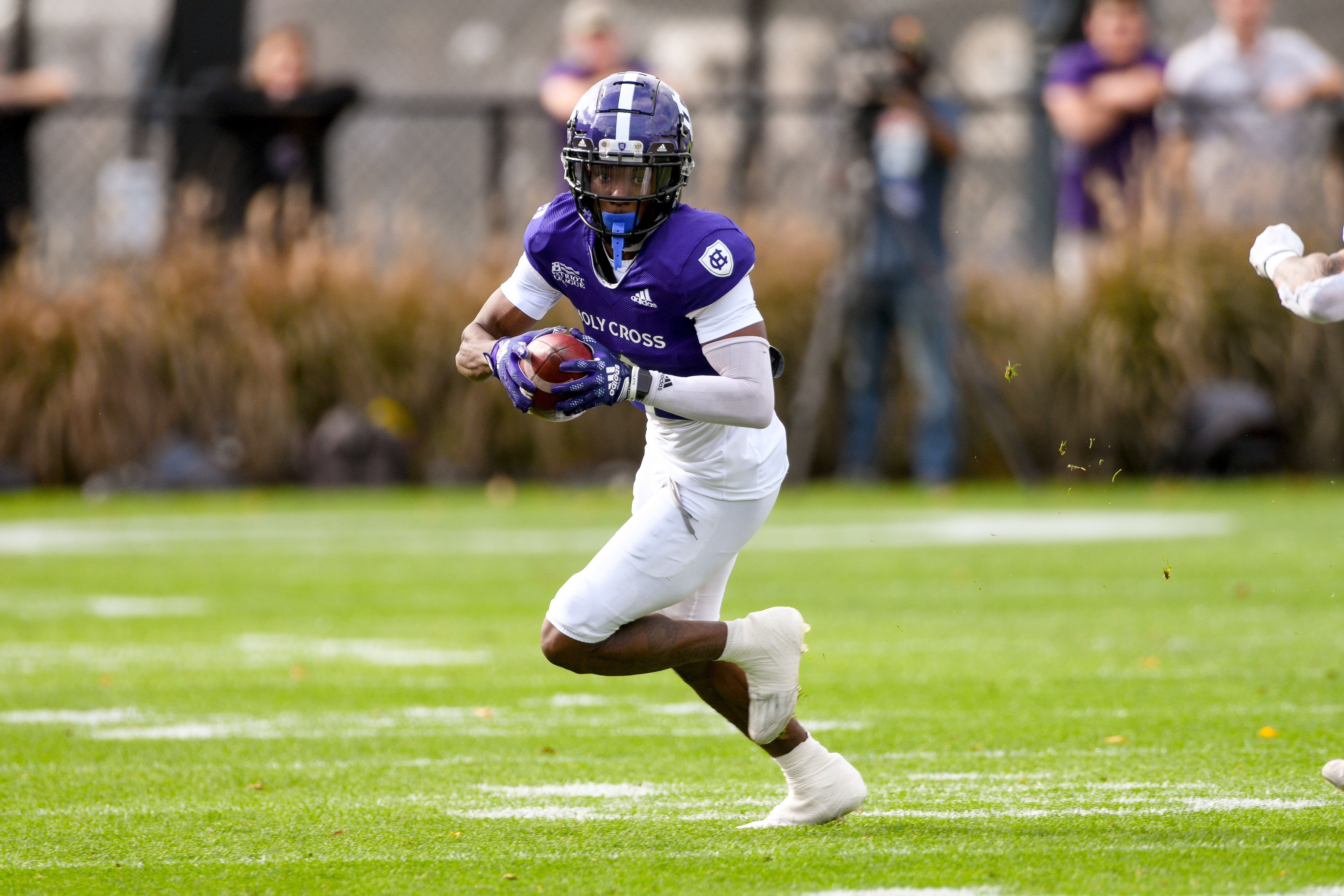Ayir Asante running with the football at Holy Cross